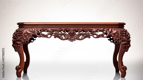 An elegant antique table with intricate carvings and a polished wood surface, isolated on a pristine white canvas. photo