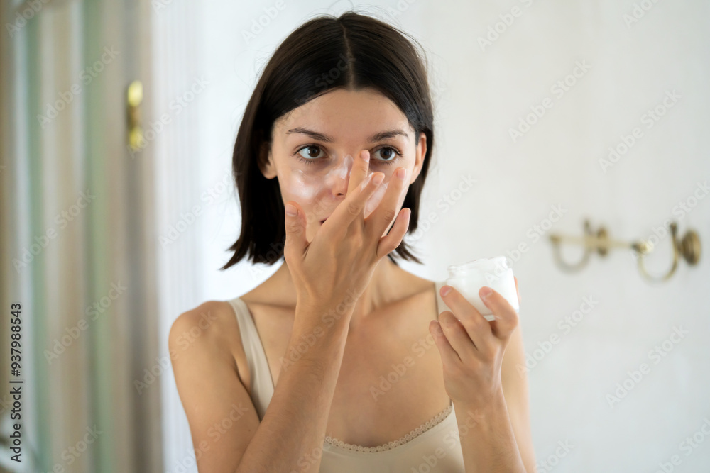Woman applies a moisturizing cream. Woman applies a moisturizing cream.