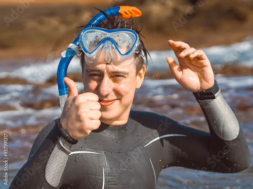 A man leads an active lifestyle, swims with a mask and a snorkel in the ocean.