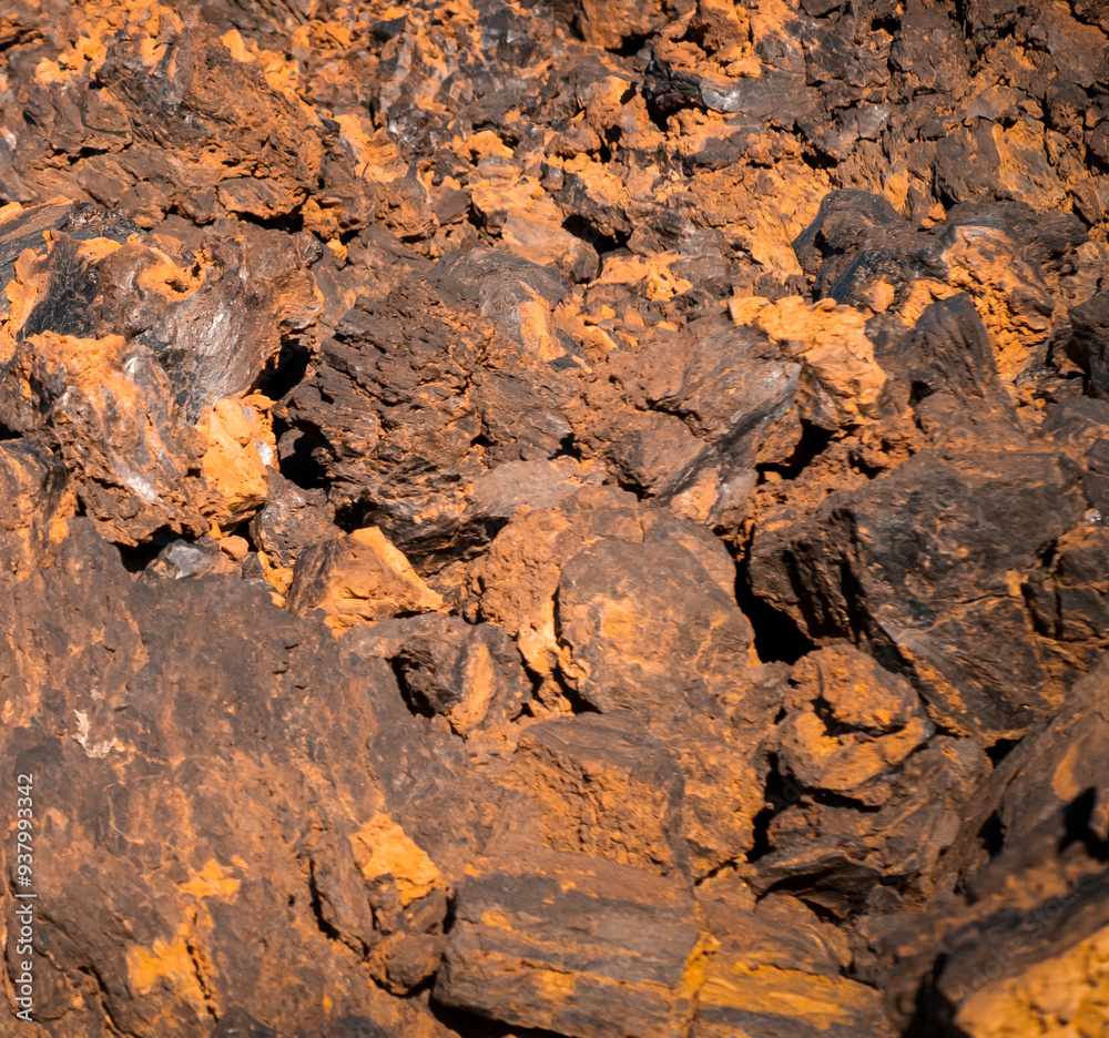 Lava formations, stones, black basalt in the rocks closeup on a volcano terrain. Lava formations, stones, black basalt in the rocks closeup on a volcano terrain.