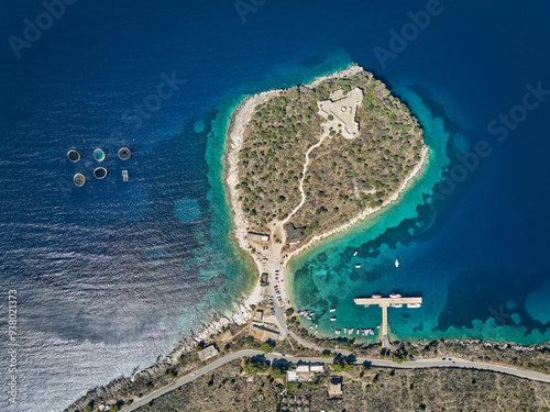 Aerial drone panorama landscape of Porto Palermo Castle (Albanian: Kalaja e Porto Palermos), beach and pier for yachts and boats, near Himare in southern Albania