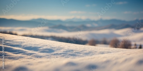 Serene snow-covered hills under soft light, creating a tranquil landscape.