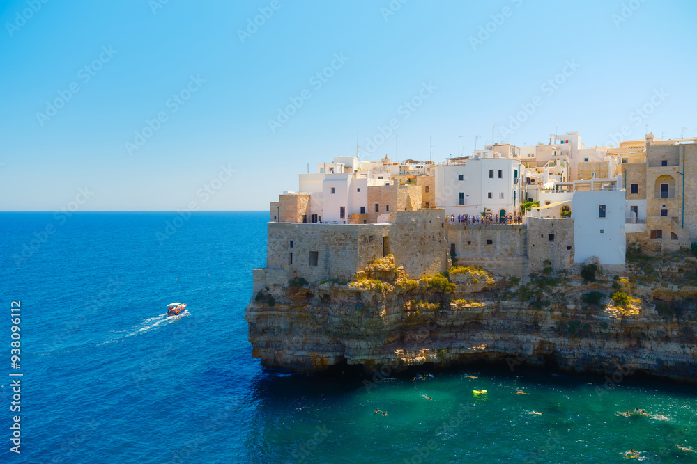 Polignano a Mare, Italy. Panoramic view of the city. Old buildings on a cliff by the sea. Italian architecture. Photos for backgrounds, wallpapers, postcards. Polignano a Mare, Italy. Panoramic view of the city. Old buildings on a cliff by the sea. Italian architecture. Photos for backgrounds, wallpapers, postcards.