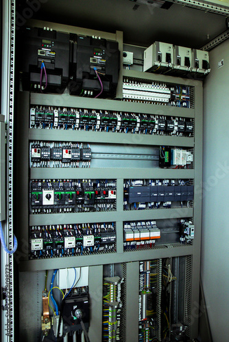 Inside view of an advanced control panel within an industrial facility, featuring various circuit breakers and switches. Essential for managing complex operations.