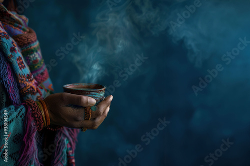 An indigenous shaman woman's hand holding a steaming cup of hallucinogenic tea. Ayahuasca ceremony. Long banner with copy space. Foggy background photo