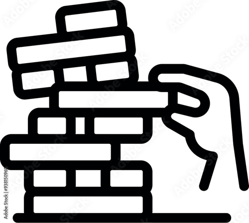 Hand is carefully removing a block from a tall tower of wooden blocks, playing the classic game of jenga