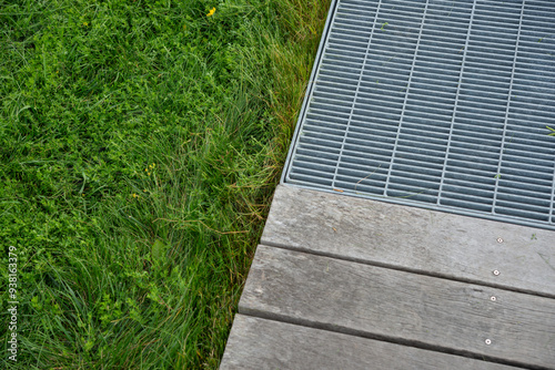 Wallpaper Mural mixed background featuring cut grass, weathered wood planks, and metal grating Torontodigital.ca
