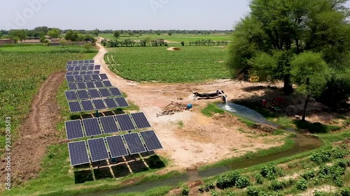 Solar tube well and water supply channel for irrigation in the field. Aerial View  photo