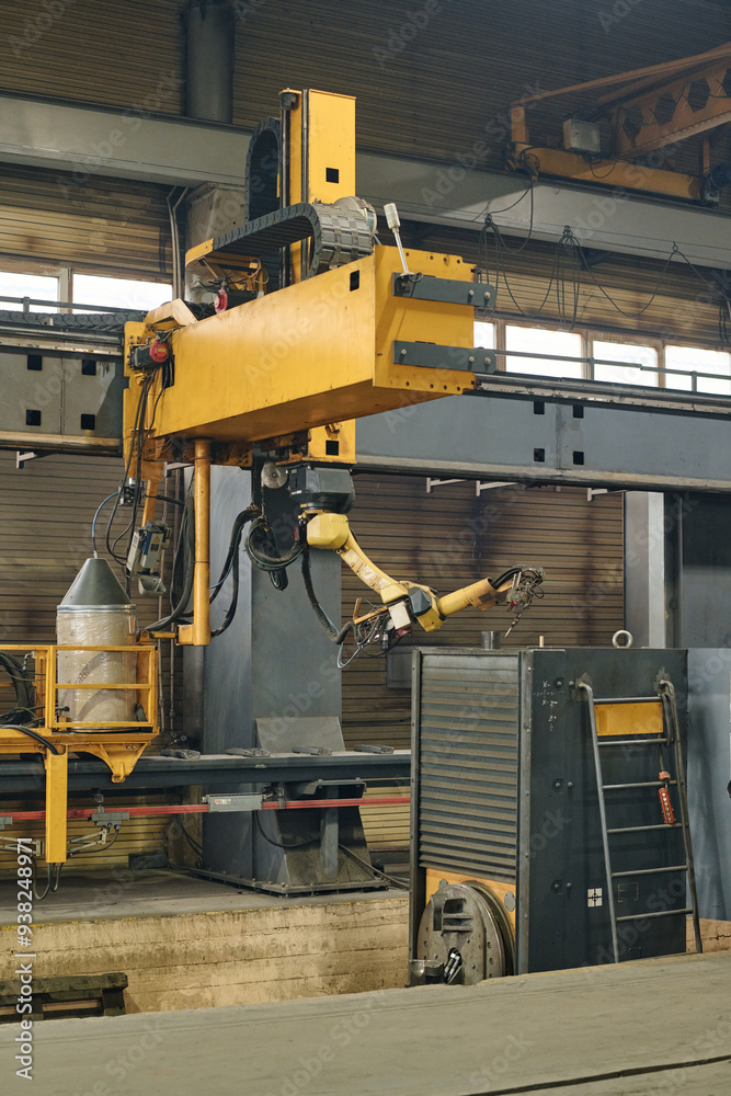 Automated machine functioning in industrial factory for assembly tasks with metals and wires being visible. Visible are the mechanical parts and some auxiliary devices being connected Automated machine functioning in industrial factory for assembly tasks with metals and wires being visible. Visible are the mechanical parts and some auxiliary devices being connected
