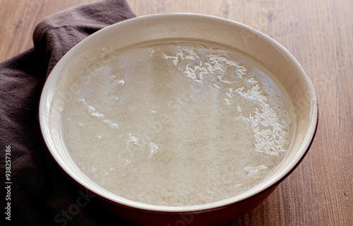 ceramic bowl, with rice soaked in water, raw rice in water, top view, no people,