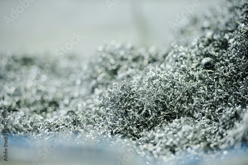 Close-up image showing detailed metal shavings in an industrial setting creating an intricate texture and pattern with a blurred background photo