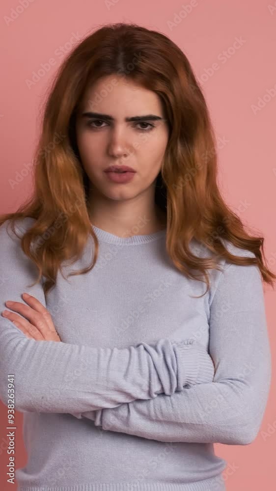 Young woman crossing arms while gesturing negation with head. Vertical Footage Young woman crossing arms while gesturing negation with head. Vertical Footage
