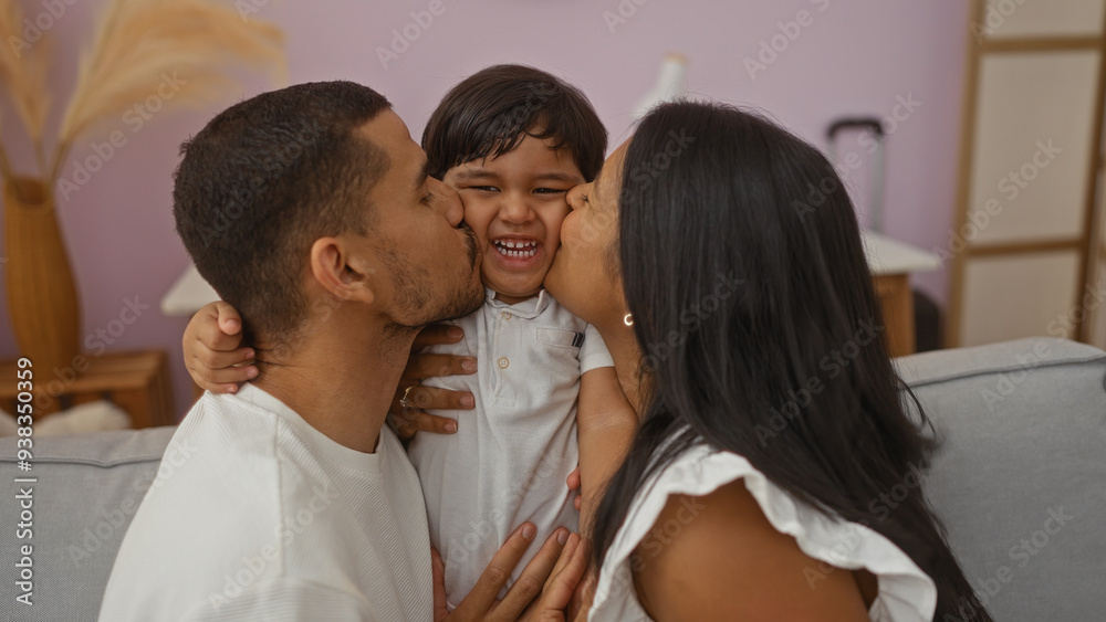 Latino family showing love as man and woman kiss their smiling child indoors in a cozy living room Latino family showing love as man and woman kiss their smiling child indoors in a cozy living room