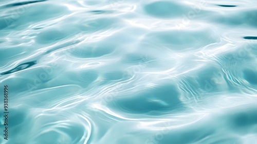 A serene close-up of gently rippling turquoise water reflecting light, creating a tranquil ambiance in a natural setting. 