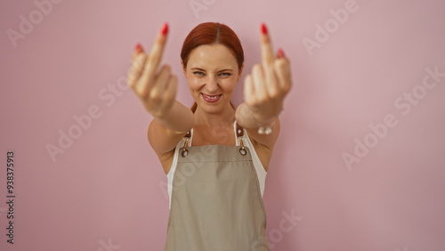 Obraz na plátně Young redhead woman flipping off with middle fingers over isolated pink backgrou