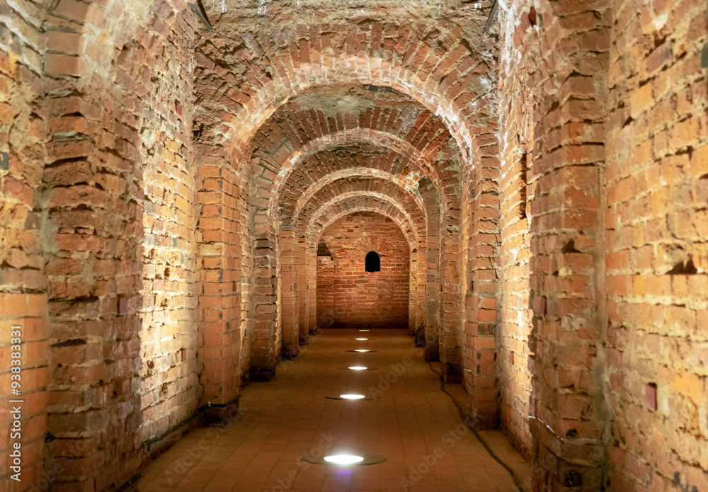 Fototapeta premium Old underground tunnel with brickwork. Stone tunnel with perspective.