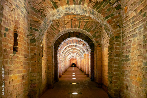 Old underground tunnel with brickwork. Stone tunnel with perspective.