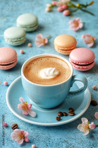 Coffee and colorful macarons on a textured blue background
