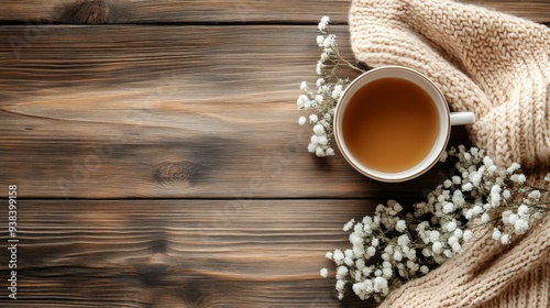 Warm cup of tea on a cozy knit blanket in a rustic setting
