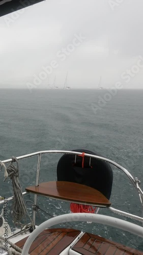 Wallpaper Mural A boat is on the water with a person looking out the window. The sky is cloudy and the water is choppy Torontodigital.ca