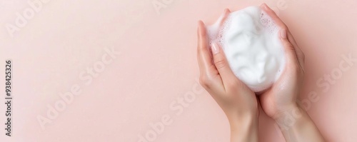 Hands massaging foamy cleanser onto the skin, skincare routine, soft and gentle