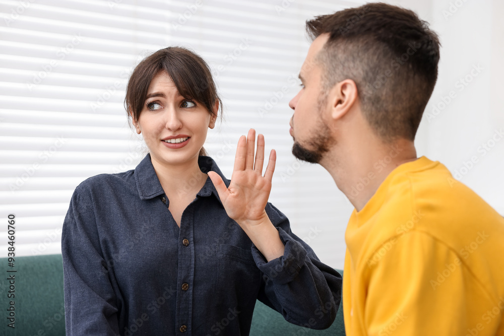 Embarrassed woman refusing from man's kiss at home Embarrassed woman refusing from man's kiss at home
