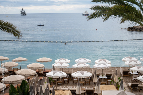 Fototapeta Naklejka Na Ścianę i Meble -  Sandy beach in Monaco, Monte-Carlo Lavrotto beach with clear sea water and beach cafe and restaurants