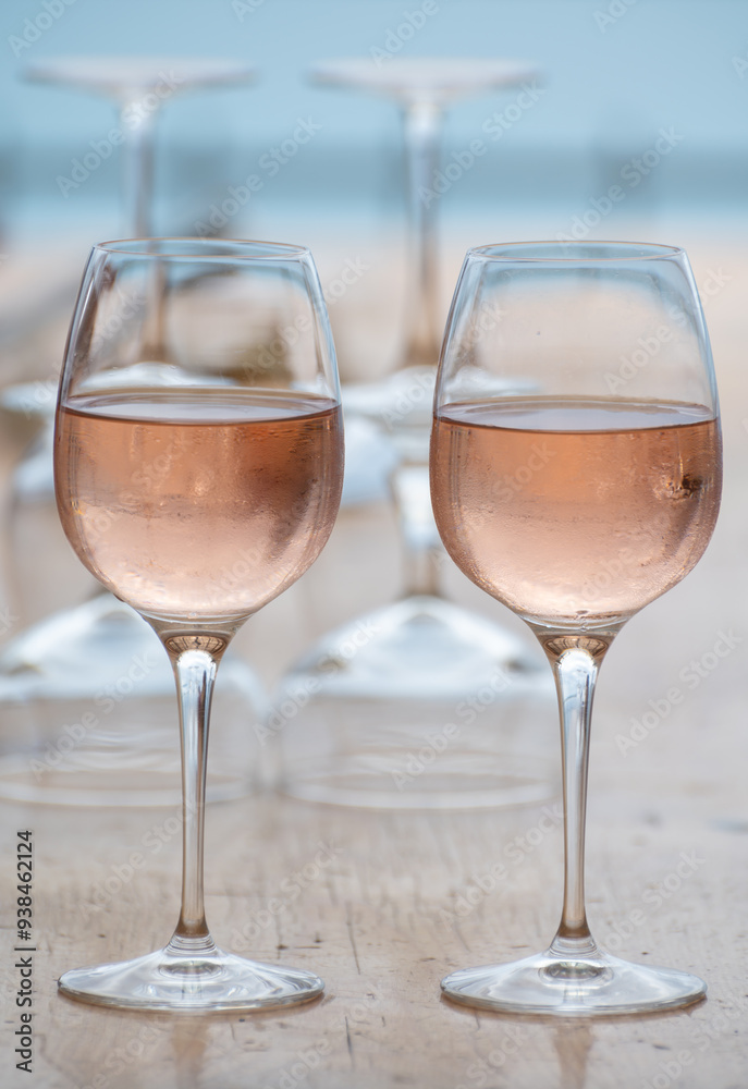 Summer time in Provence, two glasses of cold rose wine with blue sea view on background, French Riviera near Menton, south of France Summer time in Provence, two glasses of cold rose wine with blue sea view on background, French Riviera near Menton, south of France