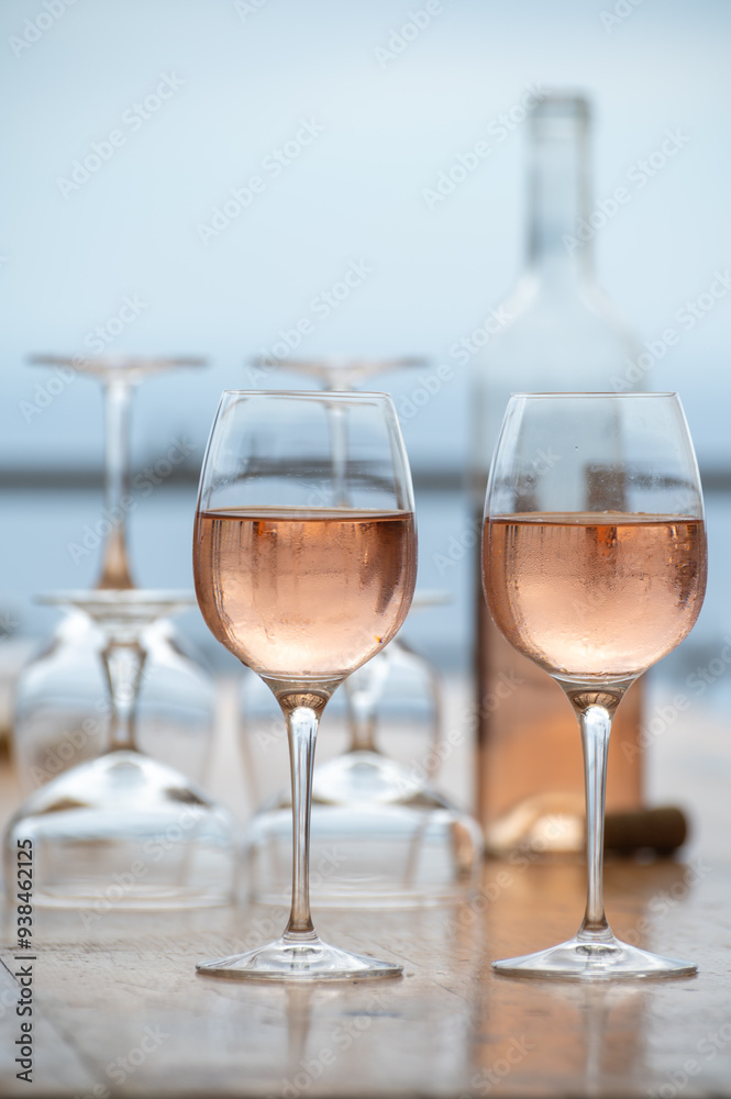 Summer time in Provence, two glasses of cold rose wine with blue sea view on background, French Riviera near Menton, south of France Summer time in Provence, two glasses of cold rose wine with blue sea view on background, French Riviera near Menton, south of France