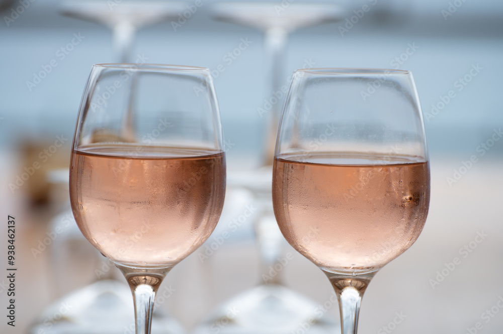 Summer time in Provence, two glasses of cold rose wine with blue sea view on background, French Riviera near Menton, south of France Summer time in Provence, two glasses of cold rose wine with blue sea view on background, French Riviera near Menton, south of France