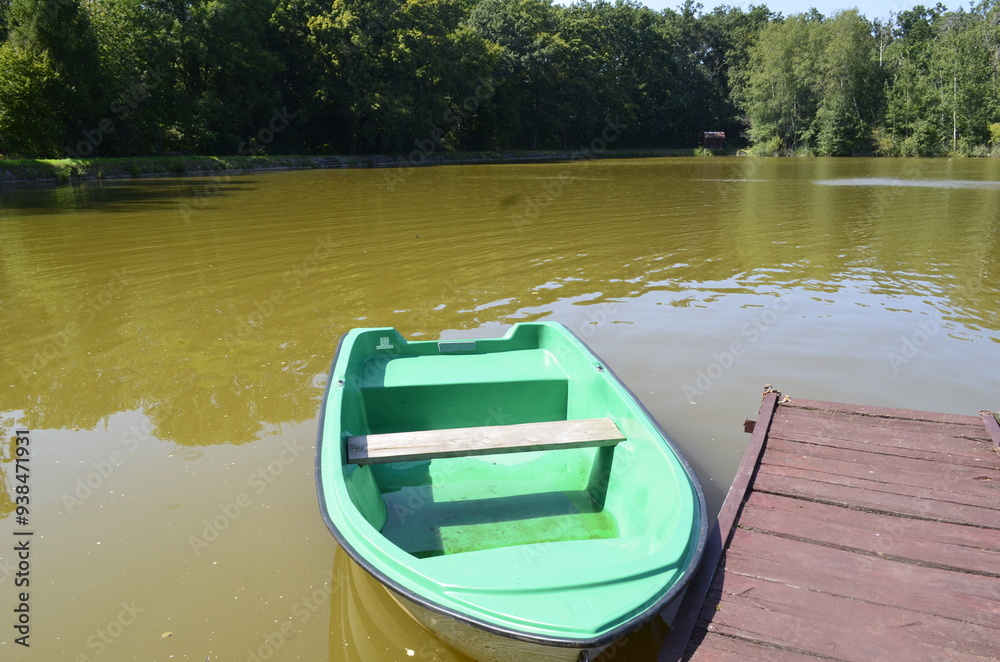 small boat standing near a wooden pier boat pier river small boat standing near a wooden pier boat pier river