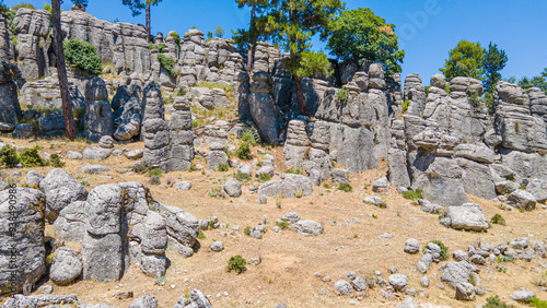 The area of conglomerates of rocks surrounding the ancient city of Selge in Antalya. The area called Avatar Land, named Rocks of Man, because it resembles a standing person, creates a fantastic image. photo