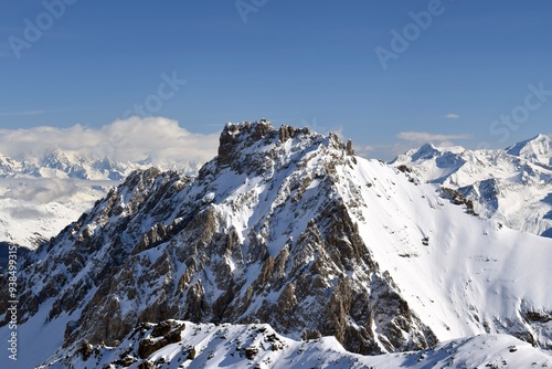 Snowcapped Alpine mountain peaks in the Three Valleys, France. Breathtaking view from popular Courchevel ski resort located in French Tarentaise Valley.