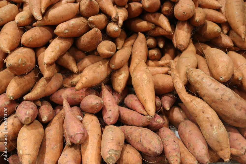 A pile of sweet potatoes for sale A pile of sweet potatoes for sale