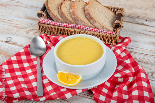 Turkish cuisine Lentil soup, melted butter and red pepper sauce. Served with bread and lemon. Local name; suzme mercimek corbasi. photo