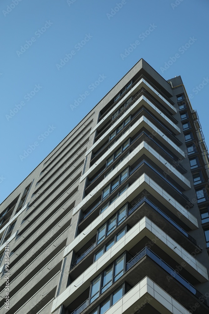 Exterior of modern building against blue sky, low angle view Exterior of modern building against blue sky, low angle view