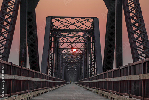 sunrise through the steel bridge