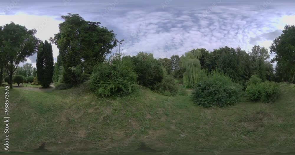 This 3 60-degree video offers a captivating journey through a stunning summer park. The verdant trees, vibrant flowers, and lush greenery create a picturesque setting that invites viewers to immerse This 3 60-degree video offers a captivating journey through a stunning summer park. The verdant trees, vibrant flowers, and lush greenery create a picturesque setting that invites viewers to immerse