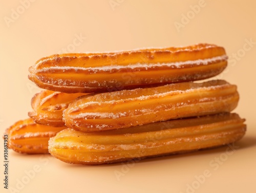 Golden crispy churros with sugar on beige background, Spanish dessert