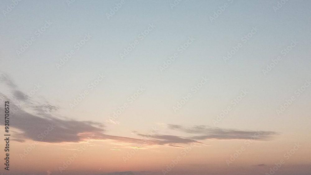 Graceful cirrus cloud drifting in the sky during a breathtaking sunset Graceful cirrus cloud drifting in the sky during a breathtaking sunset