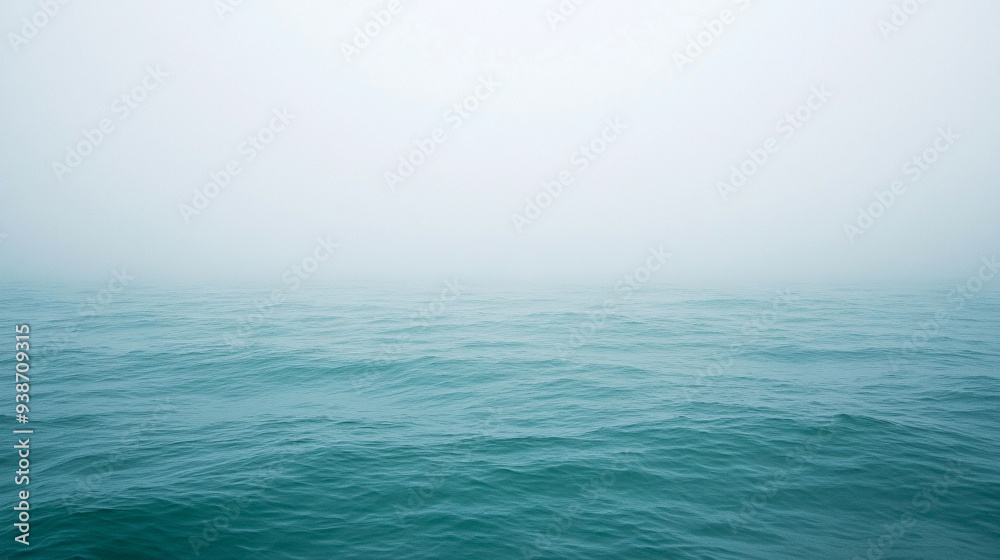 Serene lake shrouded in mist at dawn, reflecting the calm water and distant horizon. Ideal for themes of tranquility, introspection, and natural beauty Serene lake shrouded in mist at dawn, reflecting the calm water and distant horizon. Ideal for themes of tranquility, introspection, and natural beauty