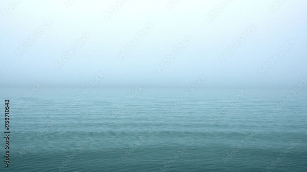 Serene lake shrouded in mist at dawn, reflecting the calm water and distant horizon. Ideal for themes of tranquility, introspection, and natural beauty Serene lake shrouded in mist at dawn, reflecting the calm water and distant horizon. Ideal for themes of tranquility, introspection, and natural beauty