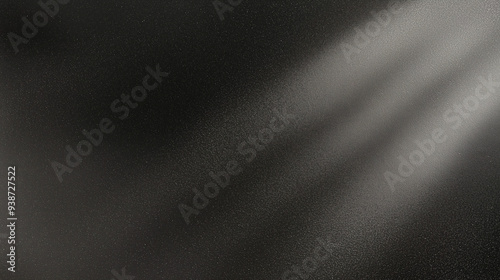 Black matte textured background with floating dust particles illuminated by soft light in the top right corner, creating a deep contrast between black and white. This abstract design emphasizes textur