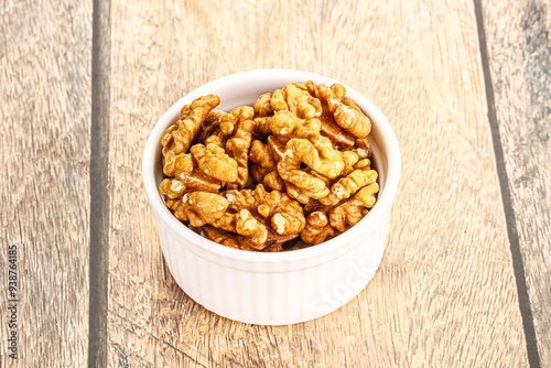 Cracked unshelled walnut in the bowl