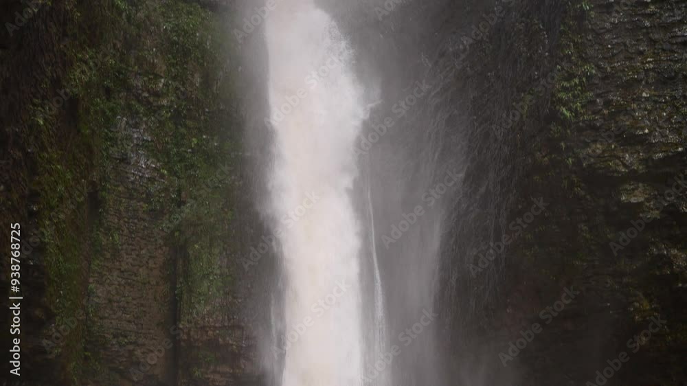 Waterfall in rainy season. Fast flowing waterfall among canyon. Soil and mud moving down after strong rain. Biggest water fall in Luyuanping, Enshi, Hubei, China.4k slow motion footage b roll shot. Waterfall in rainy season. Fast flowing waterfall among canyon. Soil and mud moving down after strong rain. Biggest water fall in Luyuanping, Enshi, Hubei, China.4k slow motion footage b roll shot.