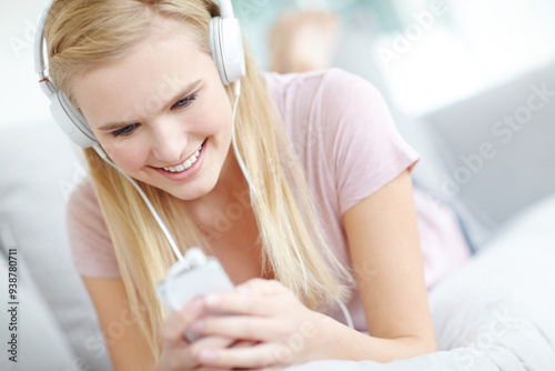 Photos Headphones, happy and woman in home listening to music, song or radio on sofa in living room