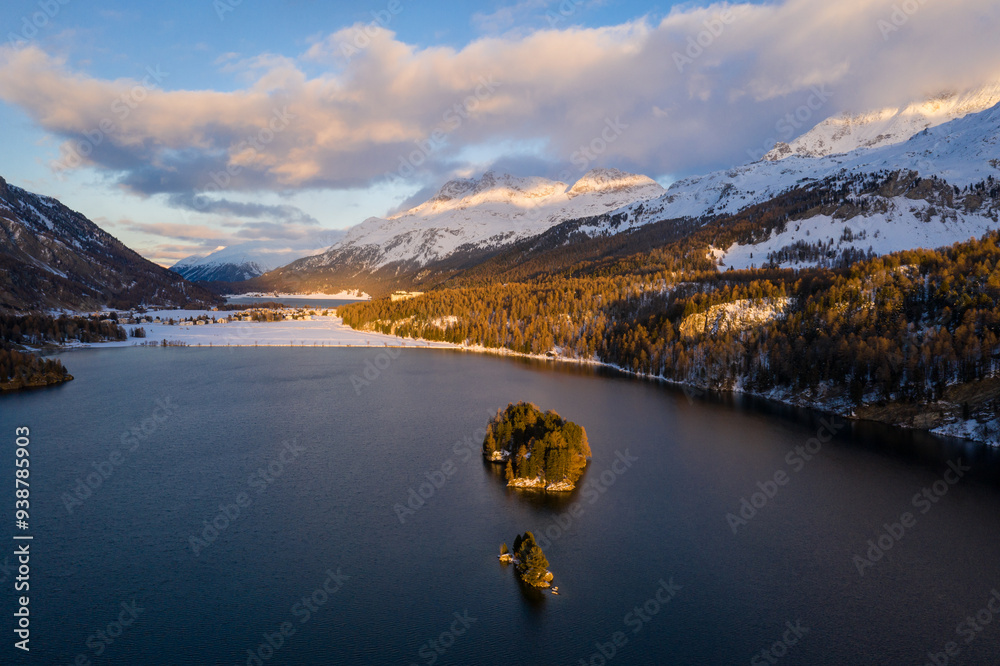 Lake Sils, Switzerland: Dramatic aerial view of the sunset over the Silsersee lake in winter in the Engadine valley in Canton Graubunden in the Swiss alps.
