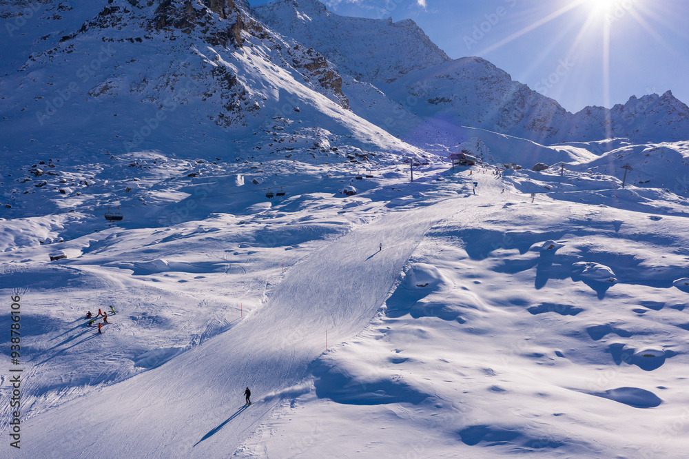 St Moritz, Switzerland: Aerial view of skiers on the slope of the Corvatsch mountain in Canton Graubunden, or Grisons, in the Swiss alps on a sunny winter day