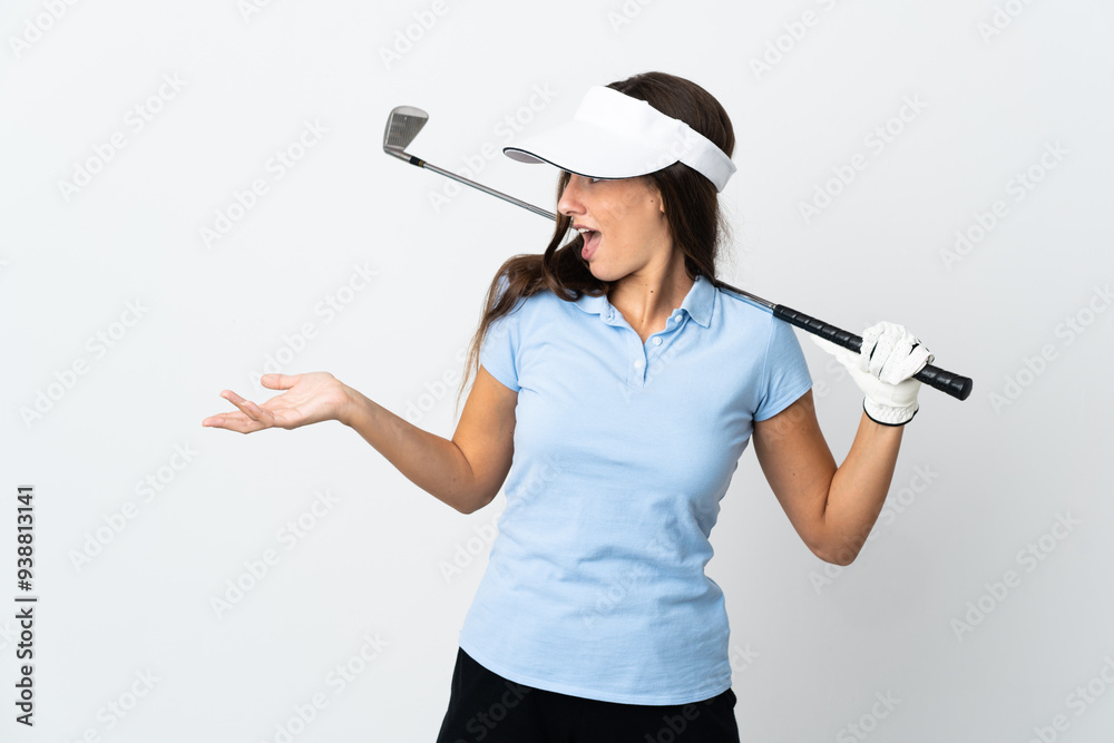Young golfer woman over isolated white background with surprise expression while looking side Young golfer woman over isolated white background with surprise expression while looking side