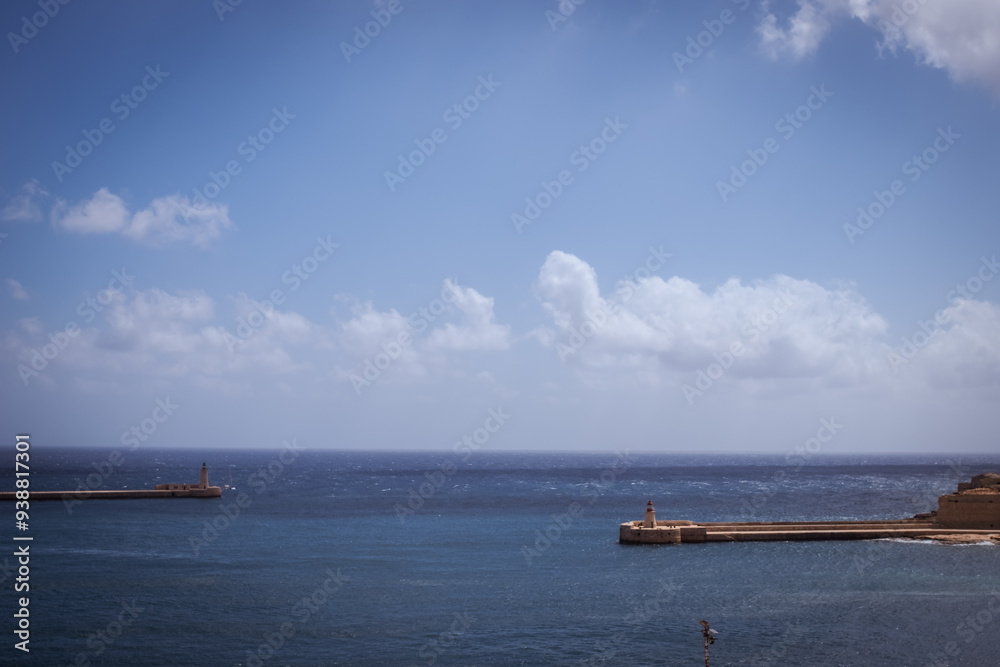 Dock pier in quiet blue waters in Mediterranean Sea in Valletta, Malta Dock pier in quiet blue waters in Mediterranean Sea in Valletta, Malta